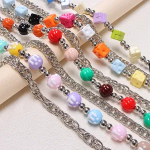 Detail of colorful M-bead and dice charms on a double-layer punk style pant chain