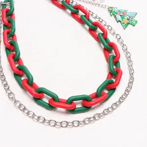 Macro view of Christmas festive layered chain featuring red green links and a tree pendant