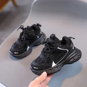 Close-up of kids black breathable mesh sneakers showing durable non-slip thick sole texture