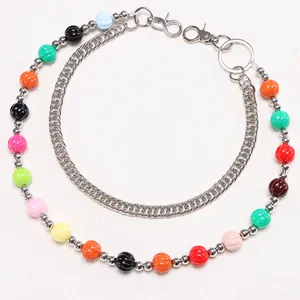 Detail of colorful acrylic beads and silver metal chain with lobster clasp and ring