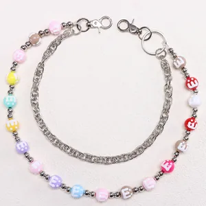 Detail of colorful M-bean resin beads and silver metal chain with lobster clasp