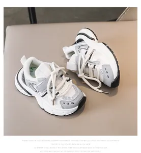 Detailed side view of mesh and faux leather kids' sneakers with hook-and-loop closure