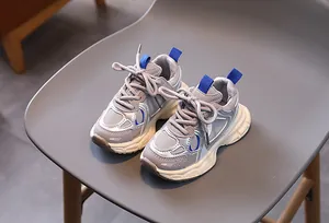 Macro detail of breathable silver mesh sneakers with blue accents on a wave-sole shoe