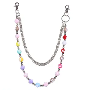 Detail of colorful M-letter beads and silver metal chain link for hip-hop pants