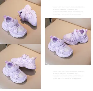 Detail of girls' purple floral sneakers with lace mesh and hook and loop closure