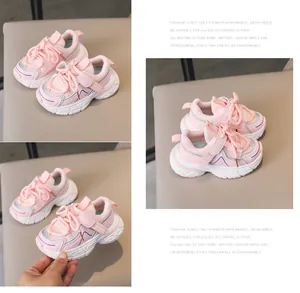 Detailed close-up of pink breathable mesh kids sneakers with Velcro and anti-slip sole