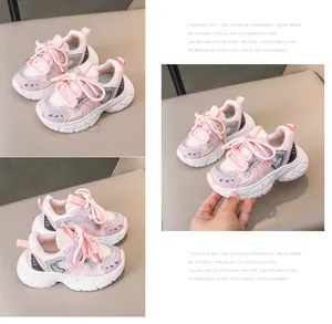 Detailed macro view of pink kids sports sneakers with soft soles and velcro strap closures