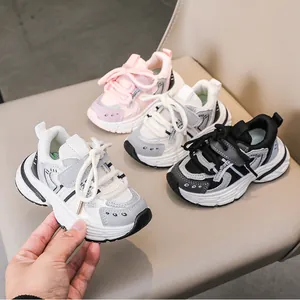 Detail shot of kids sport sneakers in pink, gray, and black with durable velcro straps