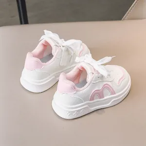 Detail von rosa-weißen Kinder-Sneakern mit geprägten Sternen und Herzsohlenmustern