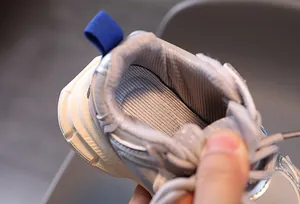 Detailed macro view of breathable honeycomb mesh lining and padded collar on kids' sneakers
