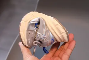 Flexible sole of kids silver sneakers showing excellent bendability and soft grip