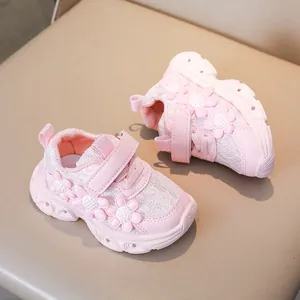 Detailed view of pink girls sneaker with 3D floral accents and lace texture details