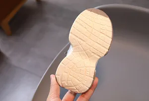 Detailed close-up of kids' sneaker sole showing anti-slip grid pattern and size 23 mark