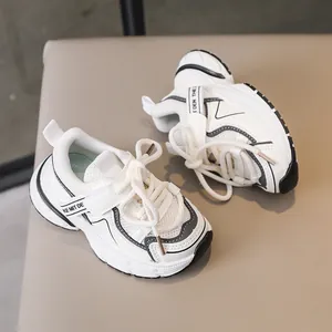 Detail of children sneakers with breathable mesh upper and velcro strap closure