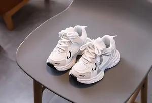 Close-up of white breathable mesh and leather details on kids chunky sports sneakers