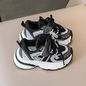 Detail view of children sports shoes with mesh upper, velcro straps and thick soles