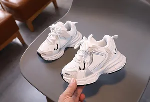 Detailed close-up of white kids dad sneakers with breathable mesh and anti-slip sole