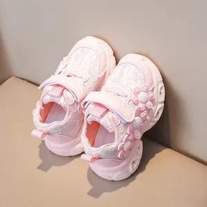 Detailed view of pink toddler shoes with 3D floral accents and lace texture details