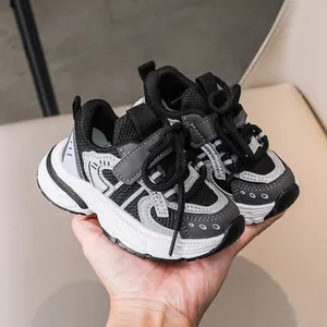 Detail showing the non-slip outsole and synthetic leather material of kids sneakers