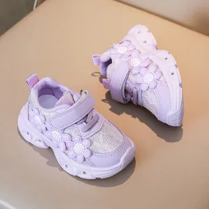 Detail view of girls purple floral sneakers with lace mesh and adjustable velcro strap