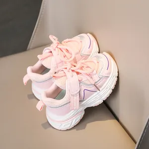 Detail of pink kids breathable mesh sneakers with durable white thick soles on a soft seat