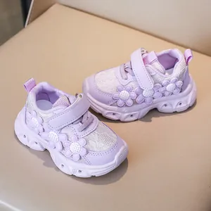 Detail of purple girls' floral sneakers with LED lights and leather mesh texture