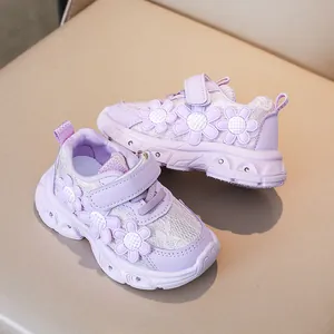 Detail view of purple girls sneakers with floral lace mesh and velcro closure straps