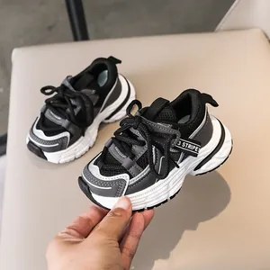 Detail of kids' chunky sneakers featuring breathable mesh and 3 stripes webbing decor