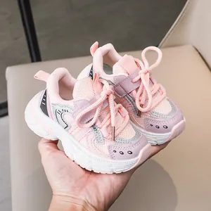 Close-up of pink kids sneakers showing breathable mesh and durable leather texture