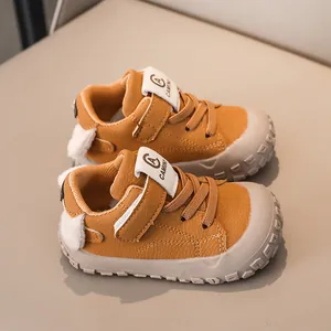 Detail view of mustard toddler shoes with durable rubber toe caps and velcro straps