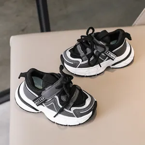 Detail view of breathable mesh and synthetic leather layers on kids chunky sports sneakers