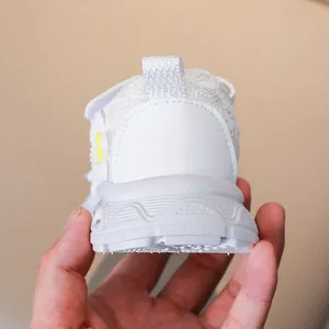 Detailed view of white toddler sneakers with floral decor and anti-slip wave sole