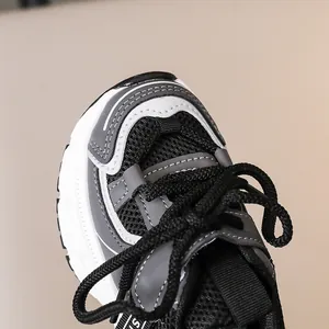 Detailed close-up of kids athletic shoes showing breathable mesh and durable toe cap