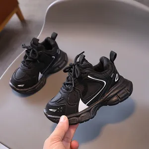 Kids black dad sneakers with soft non-slip soles and white stripe accents for running