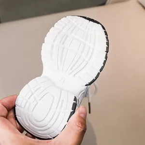 Detailed view of white anti-slip rubber outsole with size 23 marking for kids sneakers