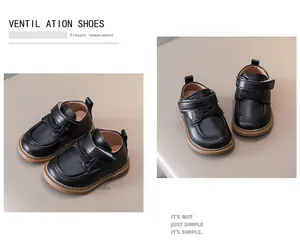 Detail view of black toddler leather shoes with hook and loop straps and rubber soles