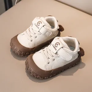Macro detail of toddler sneakers with velcro straps and brown rubber toe protection