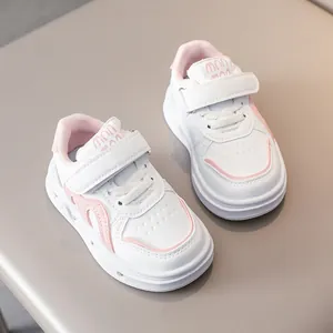 Détail de baskets basses blanches et roses pour enfants avec velcro et lacets élastiques