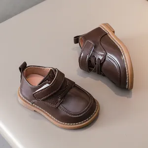 Close-up of deep brown matte leather toddler shoes with non-slip soft soles and velcro