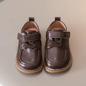 Close-up of deep brown leather baby shoes with velcro closure and durable rubber sole