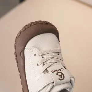Detailed close-up of baby sneaker with non-slip rubber toe cap and leather texture