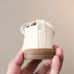 Detail of baby walking shoes with anti-slip rubber soles and soft heel straps