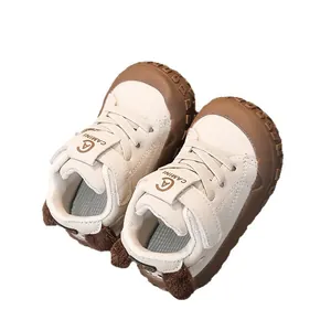 Breathable cream and brown infant walking sneakers with protective toe cap and tail detail