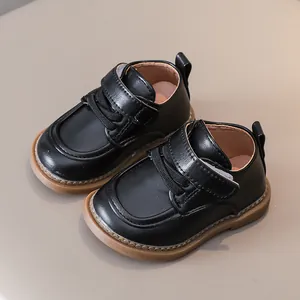 Classic black toddler leather shoes with soft rubber soles and hook-and-loop closure