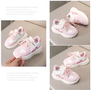 Detailed views of pink and white kids' sneakers with velcro straps and anti-slip soles