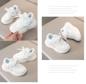 Close-up views of white kids sneakers showing thick non-slip soles and faux leather texture