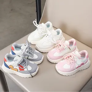 Detailed view of kids' leather sneakers in white, pink, and multi-color collage styles
