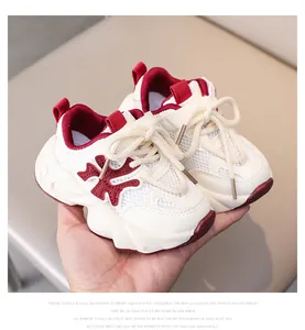 Detailed close-up of kids breathable mesh sneaker with thick anti-slip sole held in hand