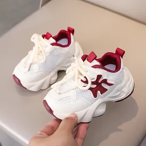 Close-up of breathable mesh material and cream laces on kids' sneakers in off-white