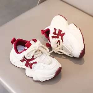 Detail view of breathable white and red mesh kids' sneakers with cushioned soles